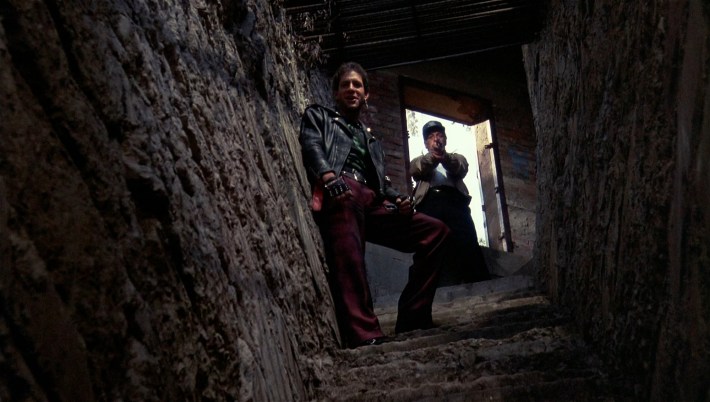 Pete Lassard (Howard Hessman), right, comes to the aid of Mahoney in a dark cave, in a scene from Police Academy 2