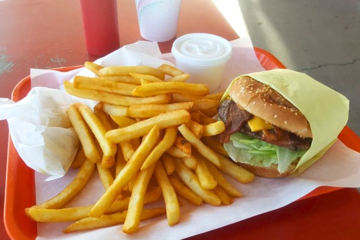 Cheeseburger with bacon and a side a fries.
